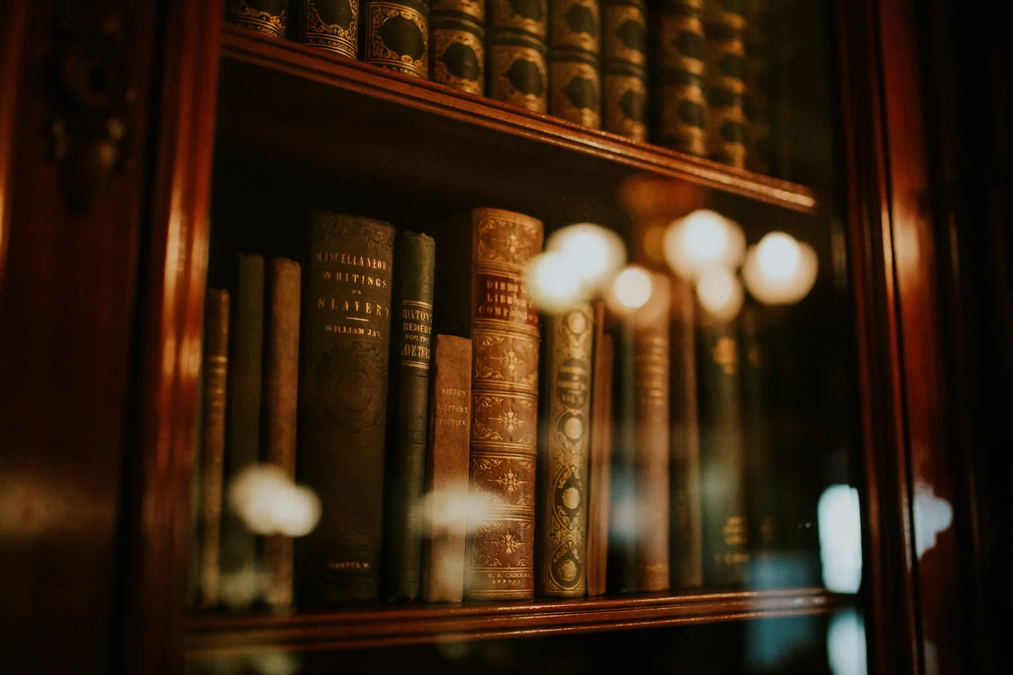 Books in a bookcase under glass, representing the text of Bill C-59 passed in Canada.